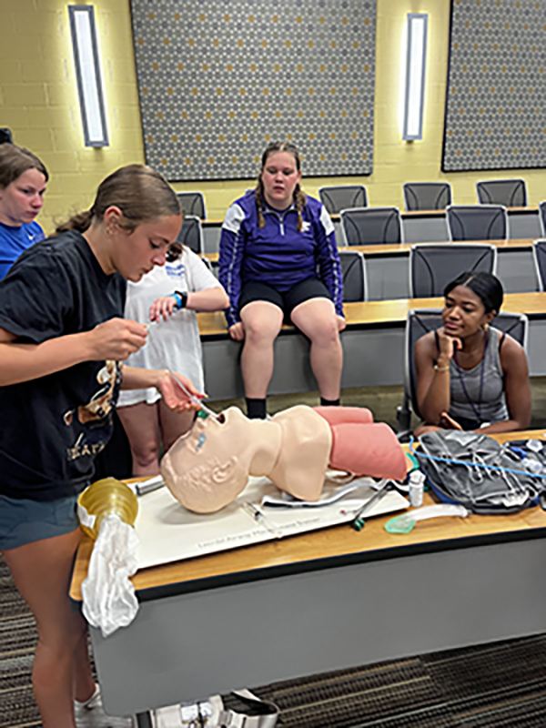 Camper practicing opening an airway