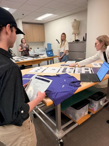 Students looking at concept products on a table at Rally House