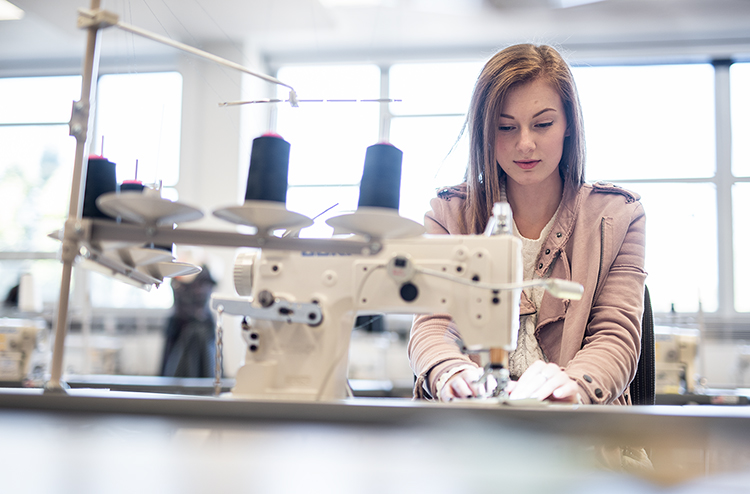 Students sewing in classroom