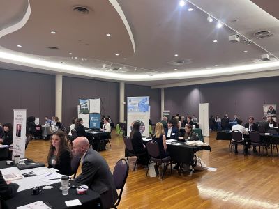 A wide view of the Professional Connections Event with firms tabling meeting with PFP students