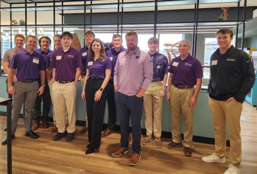 Visiting Student Group (Invest-a-Cats) posing with Ryan Cope, Vice President and Portfolio Manager, American Century.