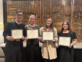 Awardees standing together with certificate