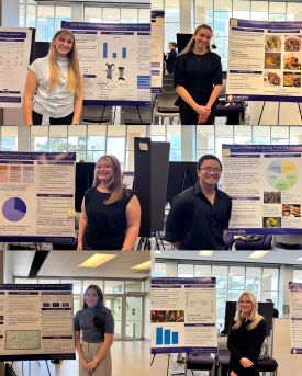 Students standing with their RSCAD posters in Justin Halls Hoffman Lounge