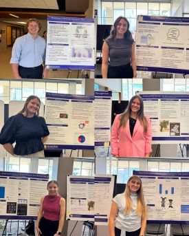 Students standing with their RSCAD posters in Justin Halls Hoffman Lounge
