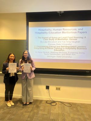 Dr. Yue Vaughn-Teng and Lili McCallum posing front of slideshow.