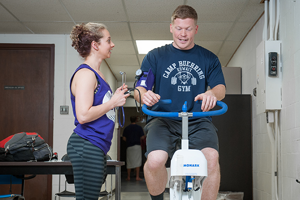 Subject on stationary bike while having vitals monitored