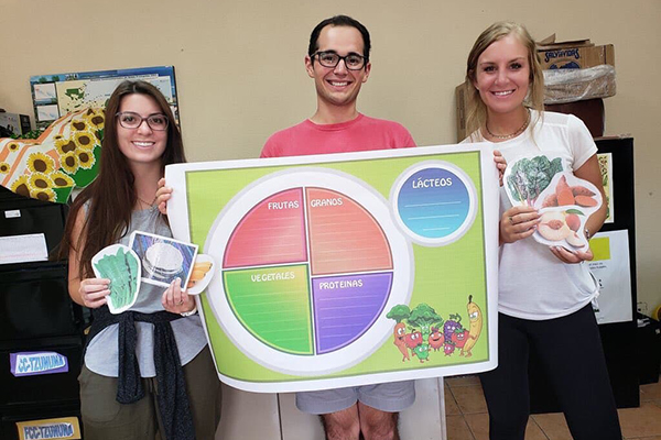 Students with a "healthy plate" poster