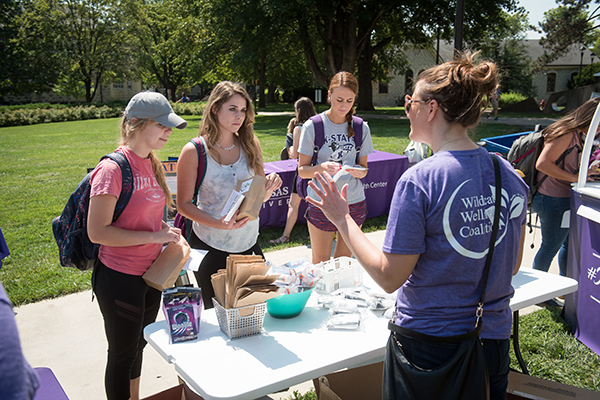 Students sharing heath information at an outdoor tabling event