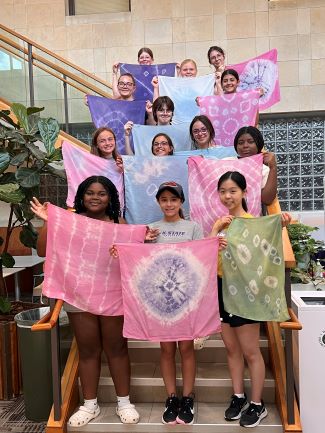 Past camper showing off their natural dye projects