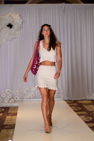 Model in white tank and skirt