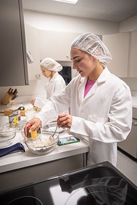 Students preparing food in the kitchen lab