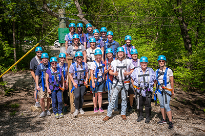 Group posing for picture at zip line activity