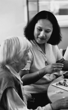 Photo of a woman working with an elderly resident