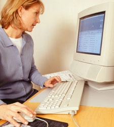 Photo of a woman working at a computer