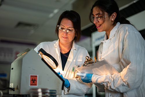 Dr. Trinetta with student in lab
