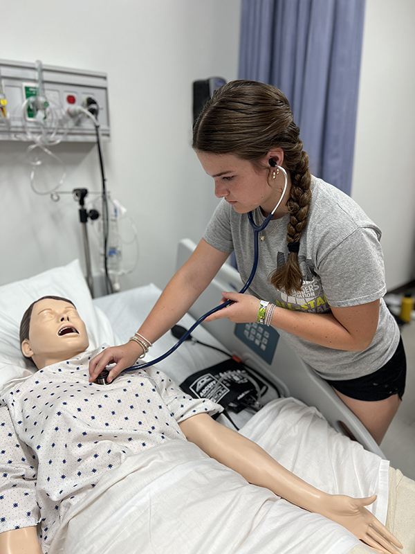 Camper listening to lung sounds